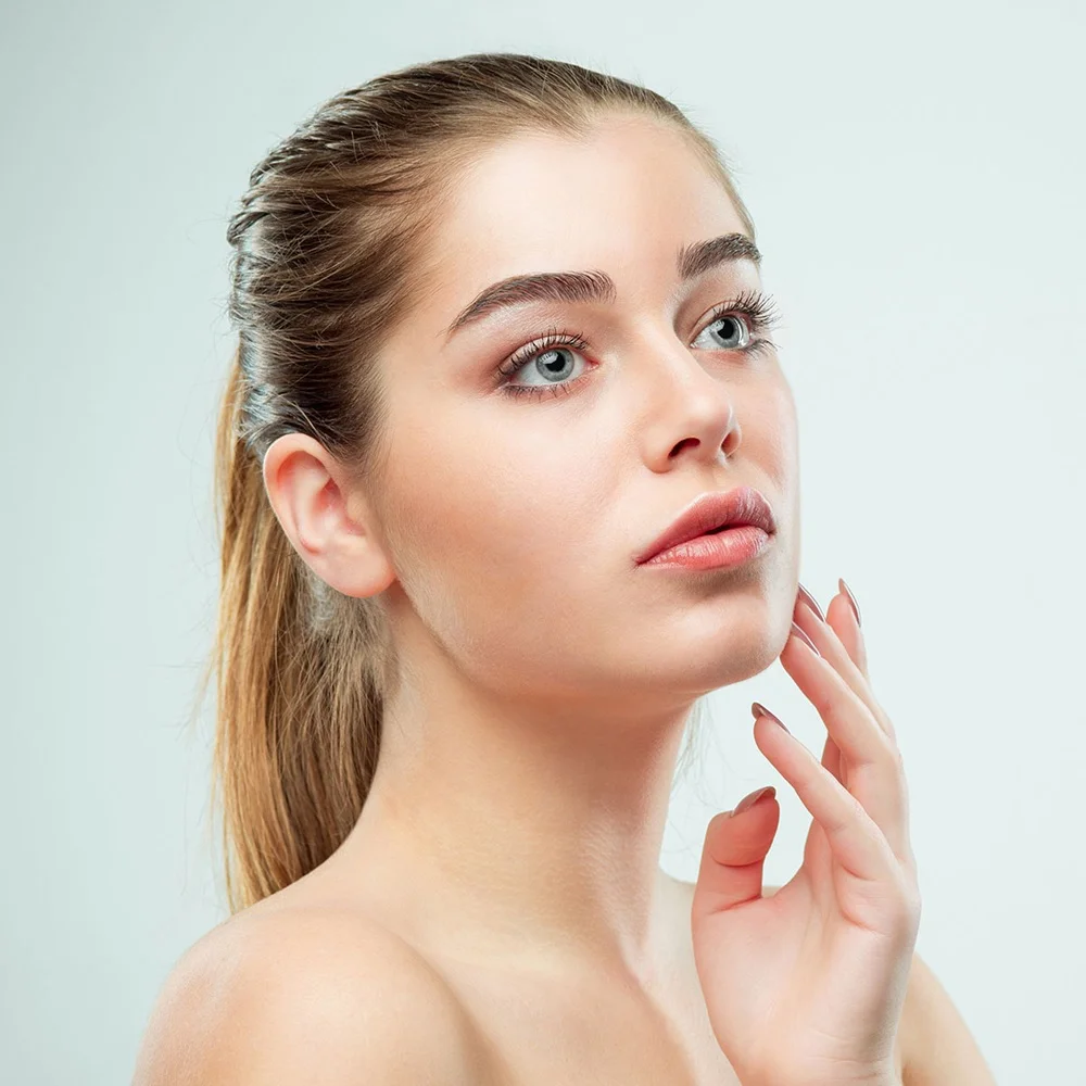 Headshot of a woman looking upward, illustrating long-lasting wrinkle and acne scar correction with Bellafill dermal filler