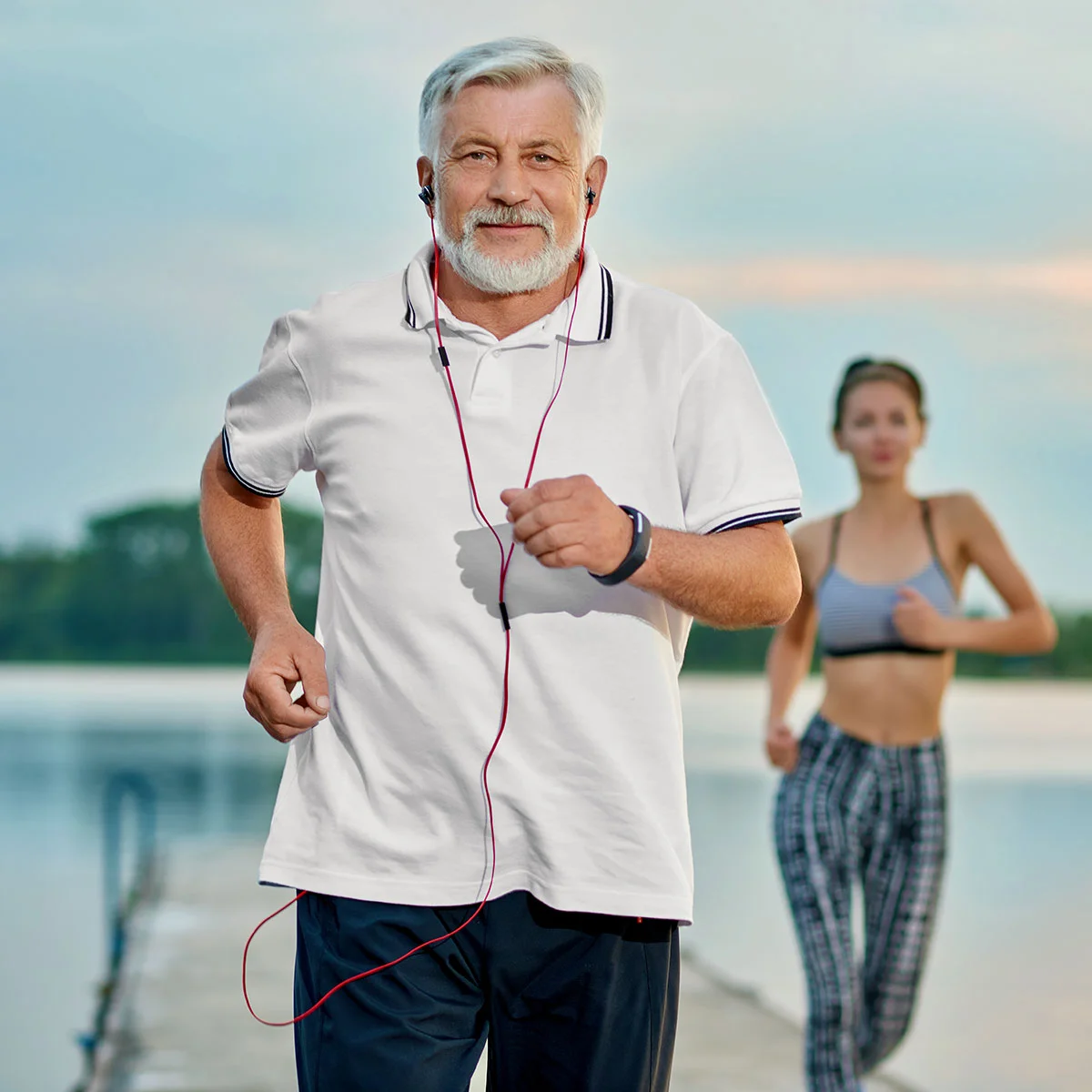Middle-aged man in athletic attire walking outdoors, highlighting increased energy levels following a low testosterone replacement therapy program.