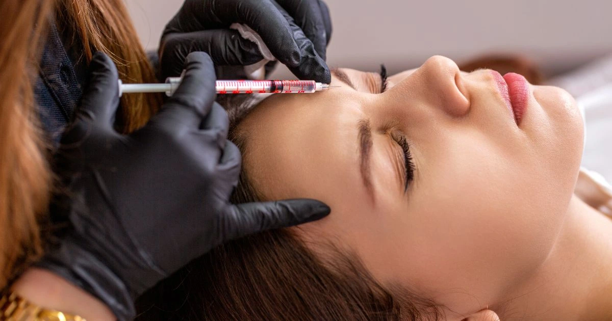 Close-up of a client receiving a Botox injection near the eye to soften crows feet and rejuvenate the eye area.