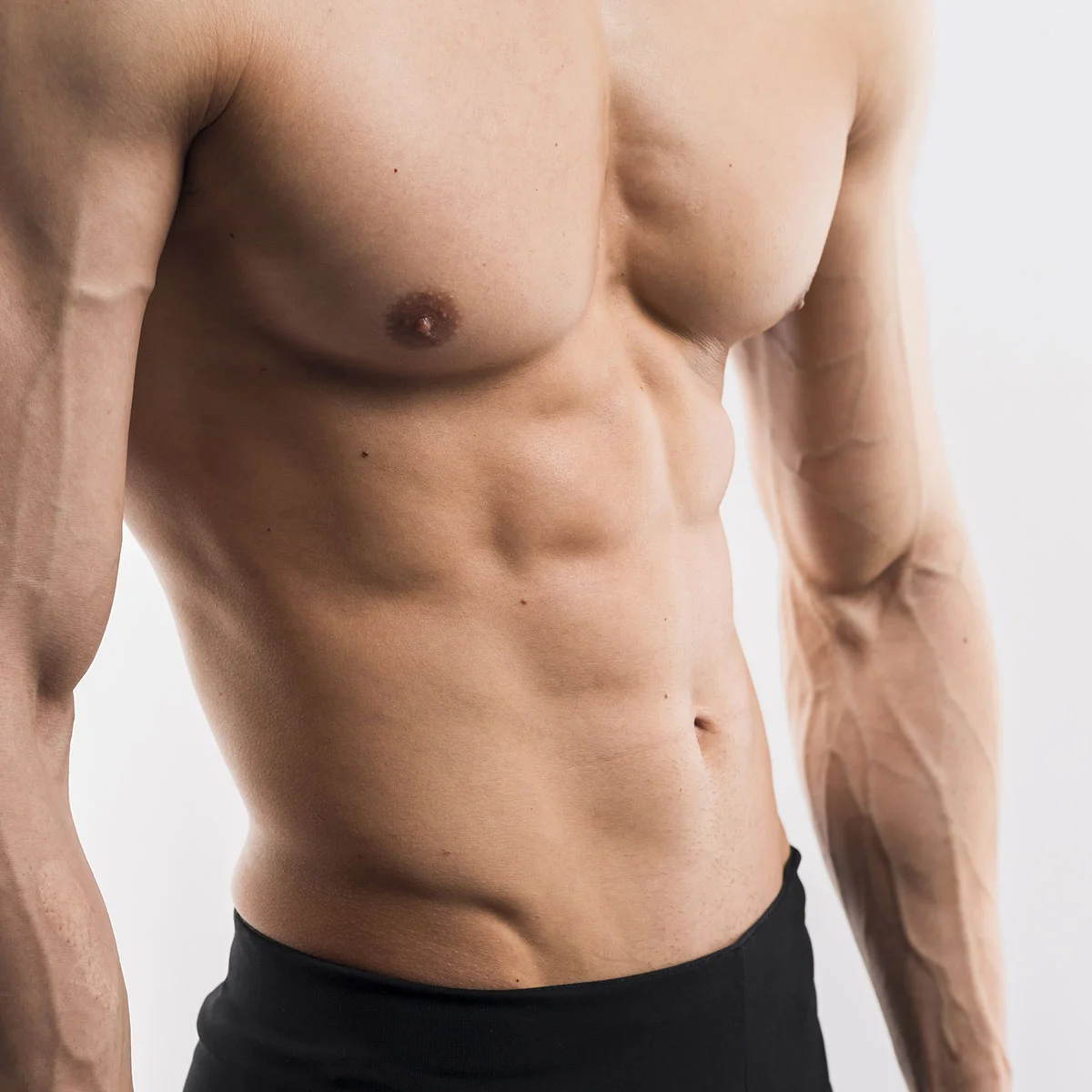 Close-up profile of a male chest contour, representing successful chest sculpting from male breast reduction surgery for gynecomastia.