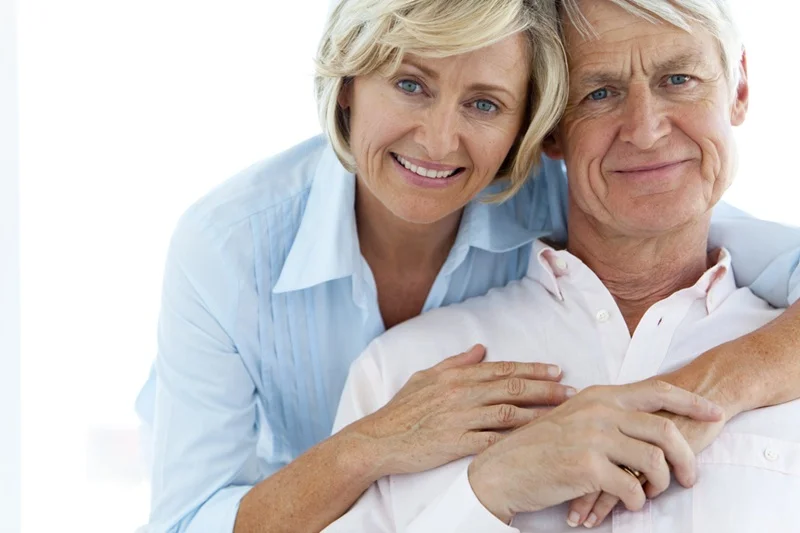 A happy senior couple embracing outdoors, highlighting improved relationship intimacy following a targeted sexual dysfunction wellness treatment